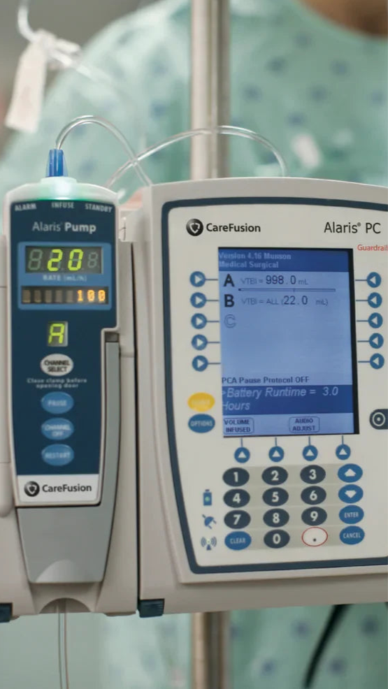 Medical equipment including an Alaris pump and CareFusion Alaris PC in a clinical setting.